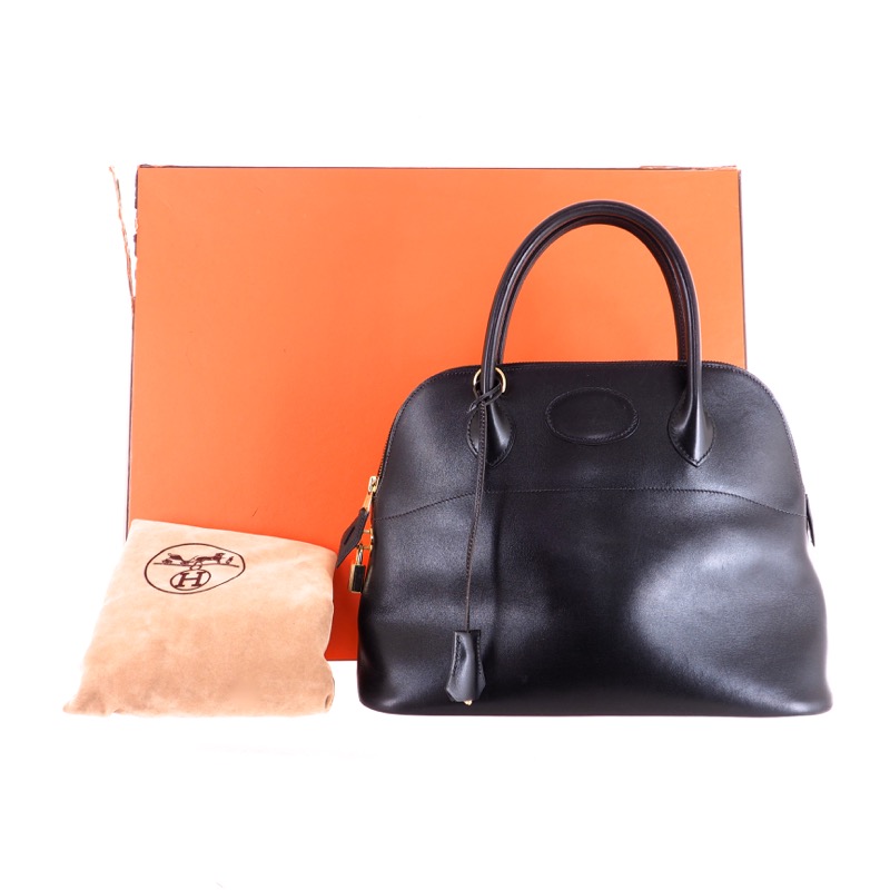 Lot - HERMES BLACK CALF BOX LEATHER BOLIDE BAG, 1991 8 1/4 x 10 1/4 x 4 in.  (21 x 26 x 10.2 cm.)